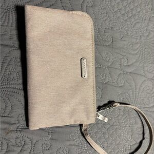Baggallini RFID wallet wristlet in a neutral beige/tan shade.